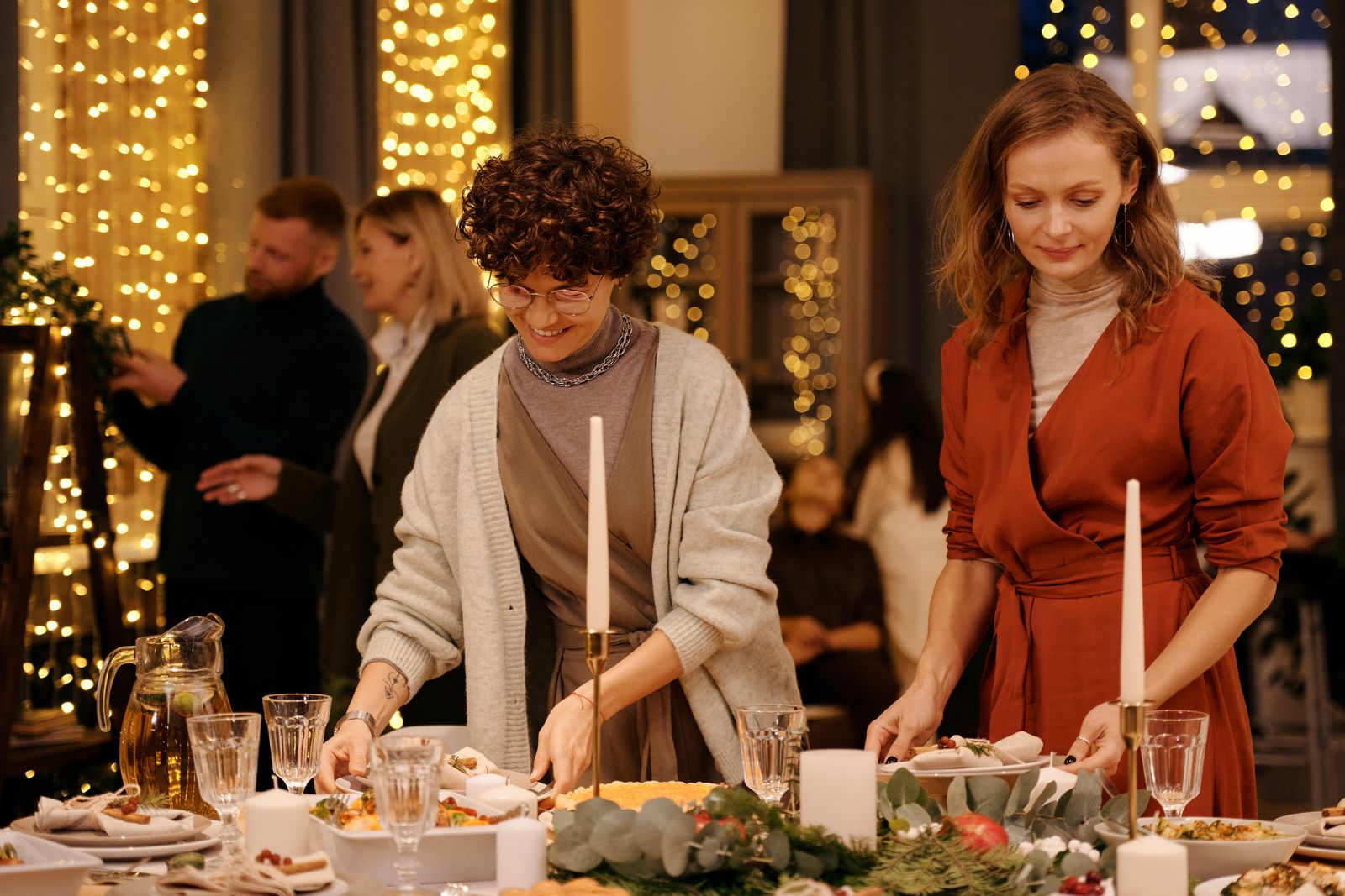 Friends setting a festive table for a dinner party